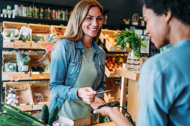 A woman buying her groceries with her fundraising gift card